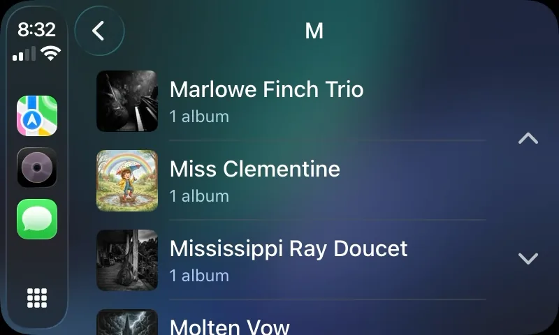 CarPlay screen for the letter M listing artists with their album artwork
